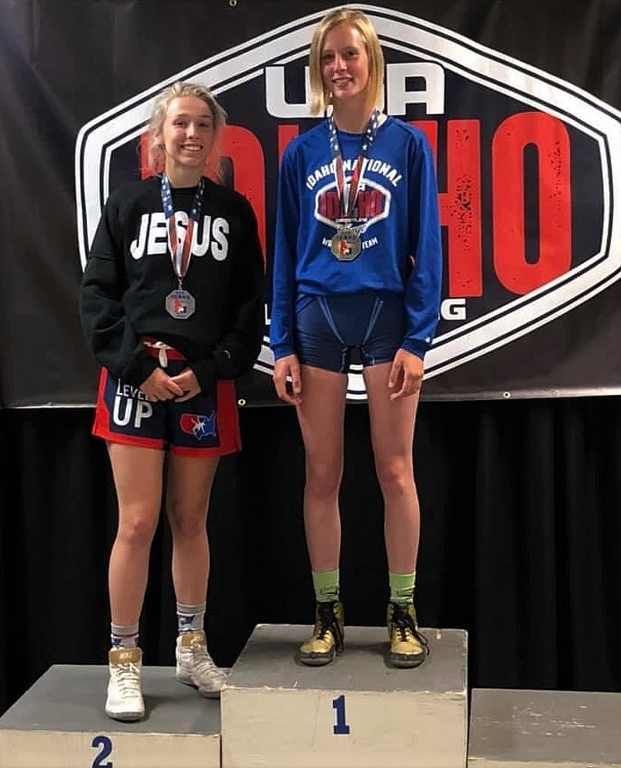 Sandpoint’s Kayelin Johansen (left) stands atop the podium to receive her second place Greco-Roman medal at 112 pounds in the girls 16U/Junior category at the USA Wrestling Idaho State Championships on July 24-25 in Twin Falls. She competed for the Lady Gladiators.