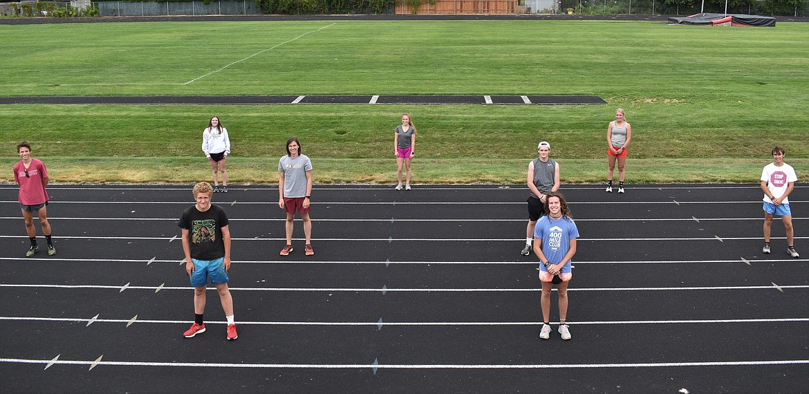 (Photo by DYLAN GREENE) 
 The nine seniors on the Sandpont cross country team pose for a socially-distanced photo. Back row (from left): Quinn Hooper, Camille Neuder and Annaby Kanning. Middle row (from left): Nikolai Braedt, Riley Christman, Nate Dotson and Keegan Nelson. Front row: Kjetil Lund-Anderson (left) and Jett Lucas.