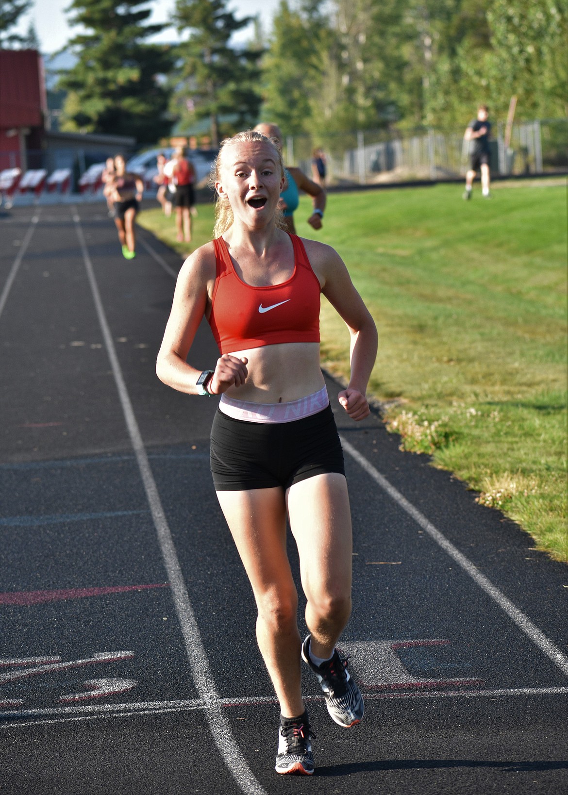 Mackenzie Suhy-Gregoire crosses the finish line during the Sandpoint mile trial on Tuesday morning and realizes she just set a new personal best.