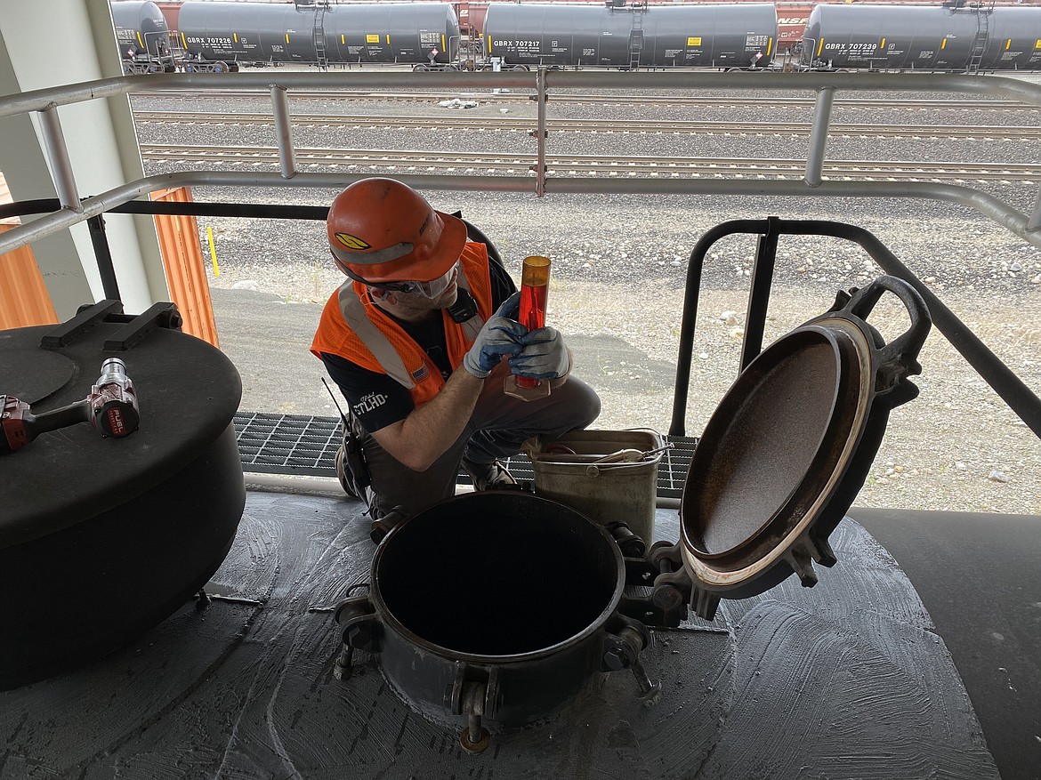 Casey Turner, a labor foreman for the Hauser fueling depot, checks the levels and purity of a diesel tanker before it leaves the facility.