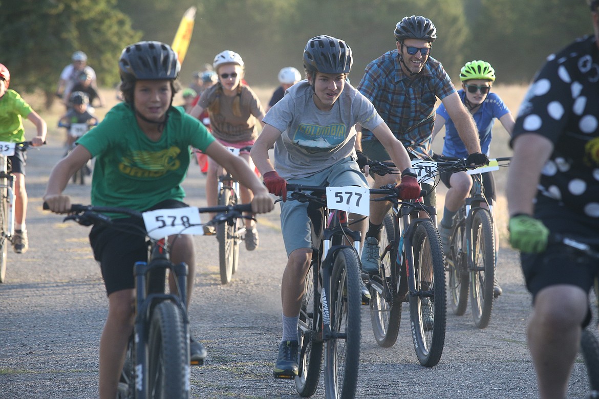 Sam Sudweeks (578), and Bene Sudweeks (577) join the crowd at the Wednesday night mountain biking series at Farragut State Park. (BILL BULEY/Press)