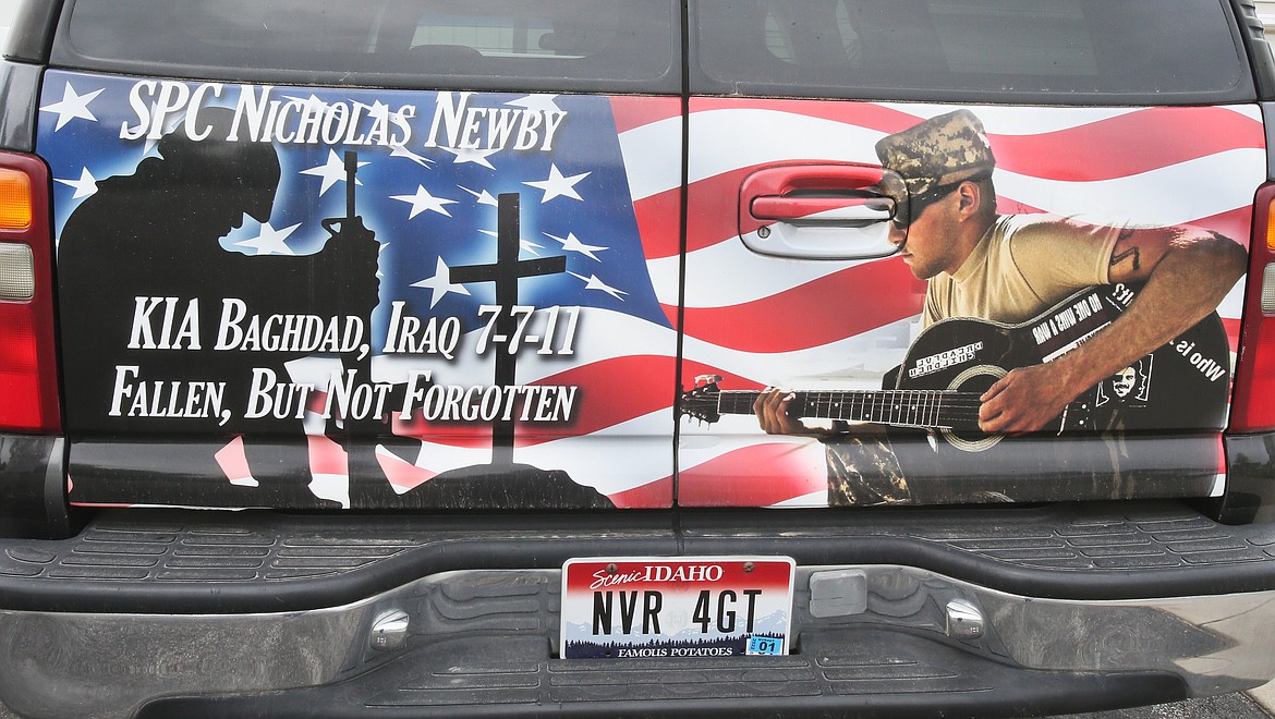 This image commemorating the life of SPC. Nicholas Newby, killed in action in 2011, is wrapped around Navy veteran Dave Sheldon's vehicle. Sheldon is friends with Newby's mom, Theresa Hart, and Sheldon plans to raise funds for the nonprofit named in Newby's honor, Newby-ginnings, by skydiving for the first time in his life, and after having two back-to-back heart attacks. (DEVIN WEEKS/Press)