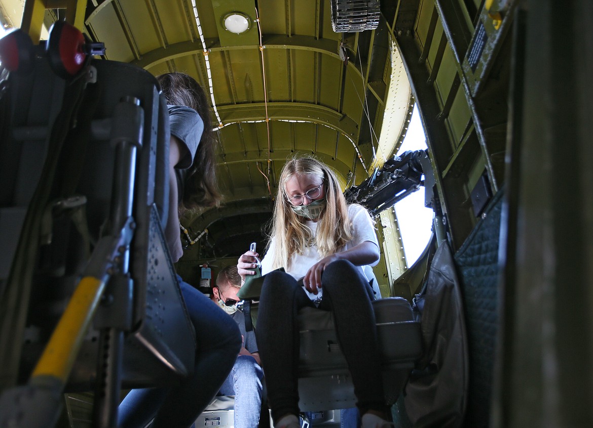 Incoming Lake City Academy eighth-grader Cambrie Stam buckles up for a ride in a historical WWII bomber during a trip with her classmates to the Coeur d’Alene Airport on Friday. (DEVIN WEEKS/Press)