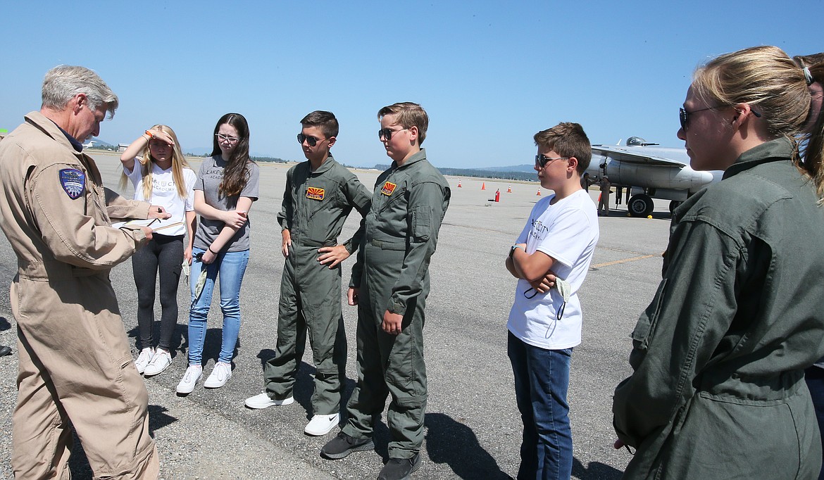 Doyle Gaines with the Commemorative Air Force, left, briefs Lake City Academy students before they go for a ride in the “Maid in the Shade” World War II bomber Friday at the Coeur d’Alene Airport.