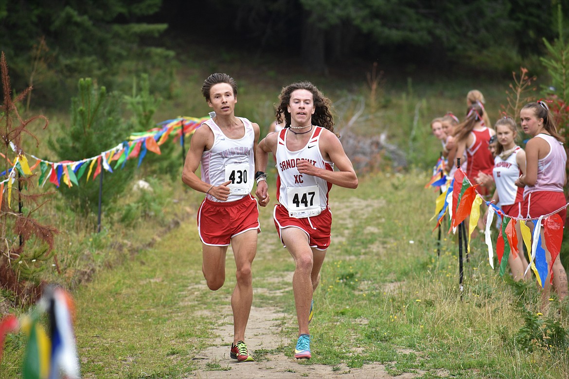 (Photo by DYLAN GREENE) 
 Nikolai Braedt (left) and Jett Lucas run side-by-side to the finish during Friday's dual meet.