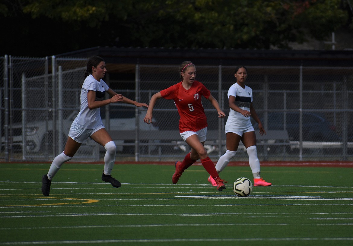 (Photo by DYLAN GREENE) 
 Junior Ashlee Webster splits through the Lake City defense on Friday at War Memorial Field.