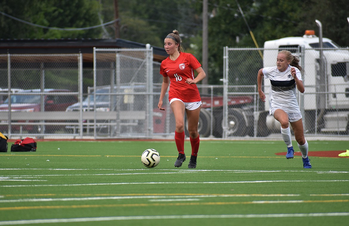 (Photo by DYLAN GREENE) 
 Junior Kylie Williams looks for an open teammate during Friday's game at War Memorial Field.