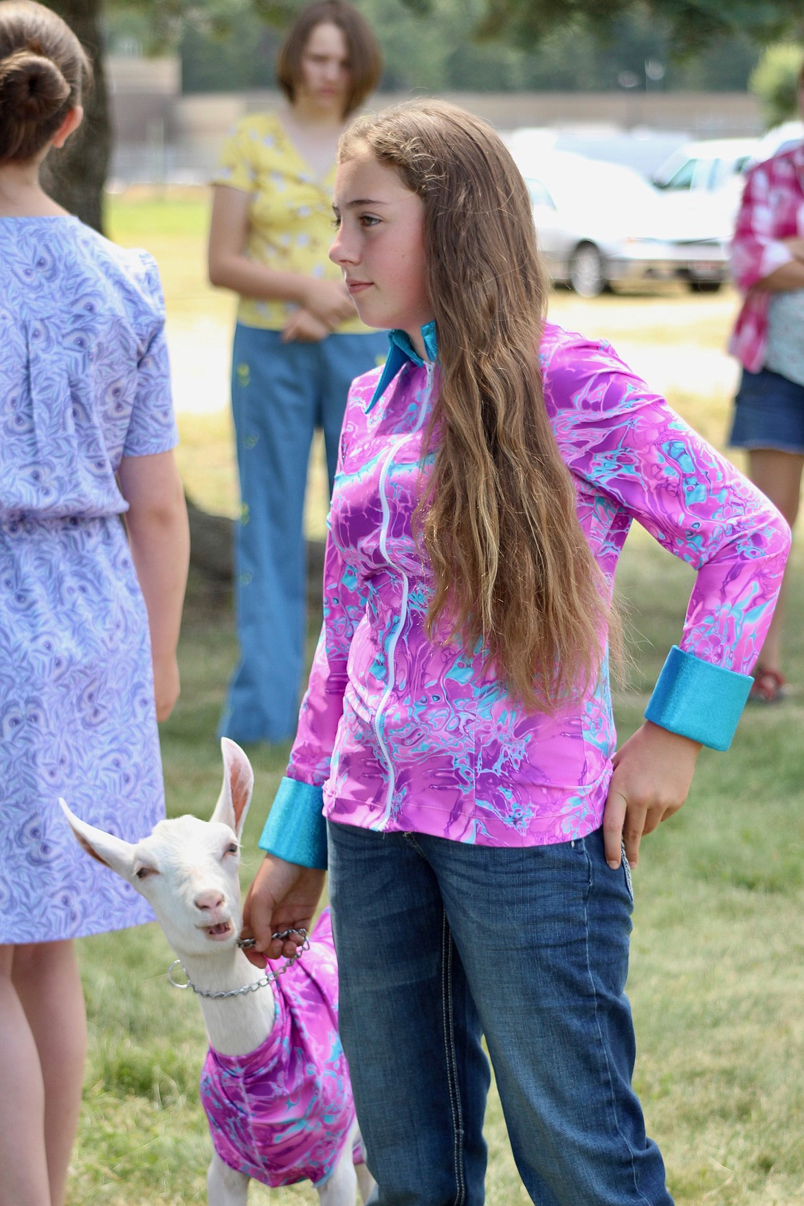 Sagle Saddle Tramps club member CayliJo Giard, 12, and her 5-month-old Saanen doeling, Matilda Jane, model their colorful outfits sewed by Giard during the Bonner County 4-H Fashion Revue Friday at the Bonner County Fairgrounds. Giard has been in the sewing project for four years and sewed her top for showing horses. “I just instantly fell in love with this fabric,” she said.
