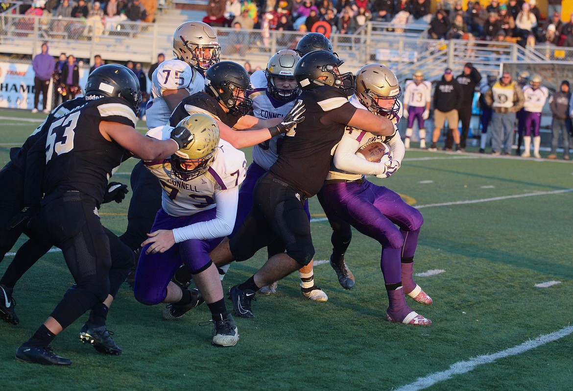 Casey McCarthy/Columbia Basin Herald Royal’s Michael Perez wraps up the Connell player for the tackle in the second half on Saturday afternoon in Moses Lake.