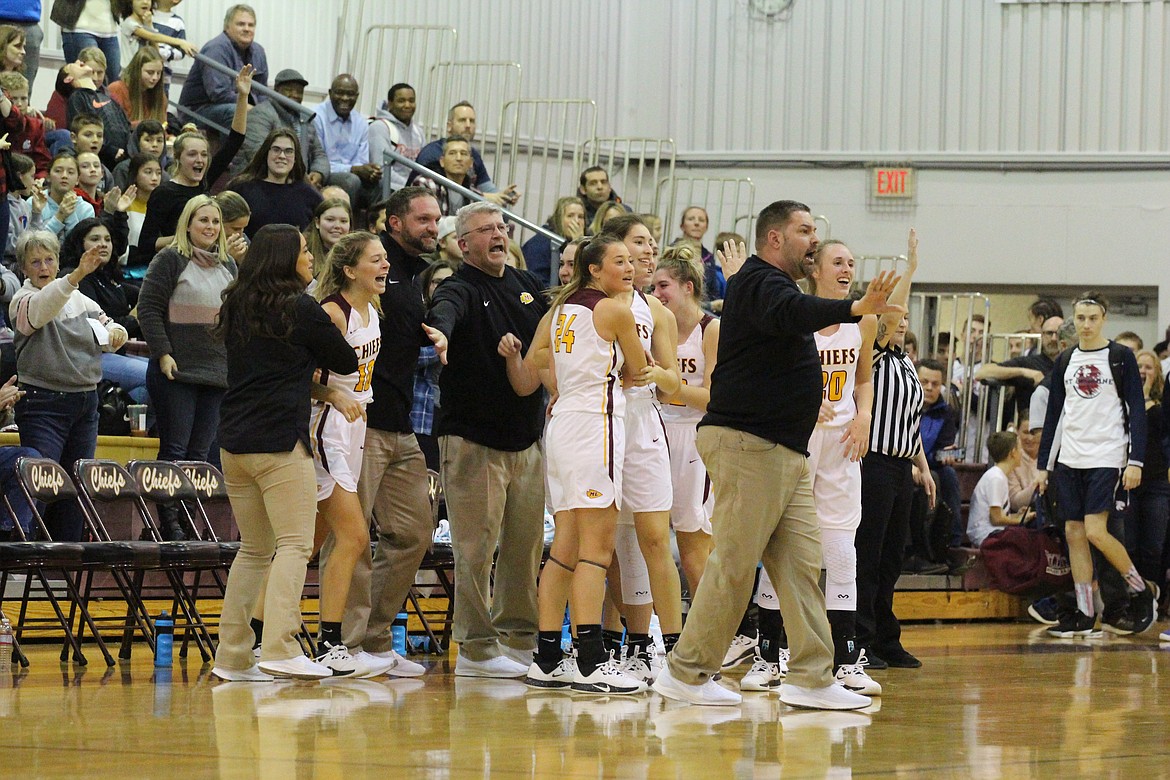 Casey McCarthy/Columbia Basin Herald Chiefs players and coaches celebrate after Anna Olson’s layup puts Moses Lake in front with less than a second to play on Tuesday.