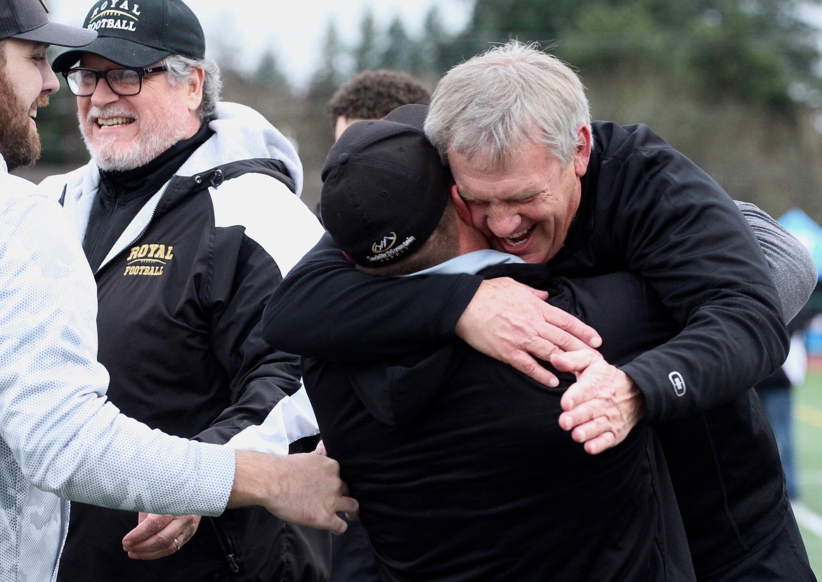 Casey McCarthy/Columbia Basin Herald Royal coaches embrace after the Knights defeated Lynden Christian on Saturday to claim the 1A title.