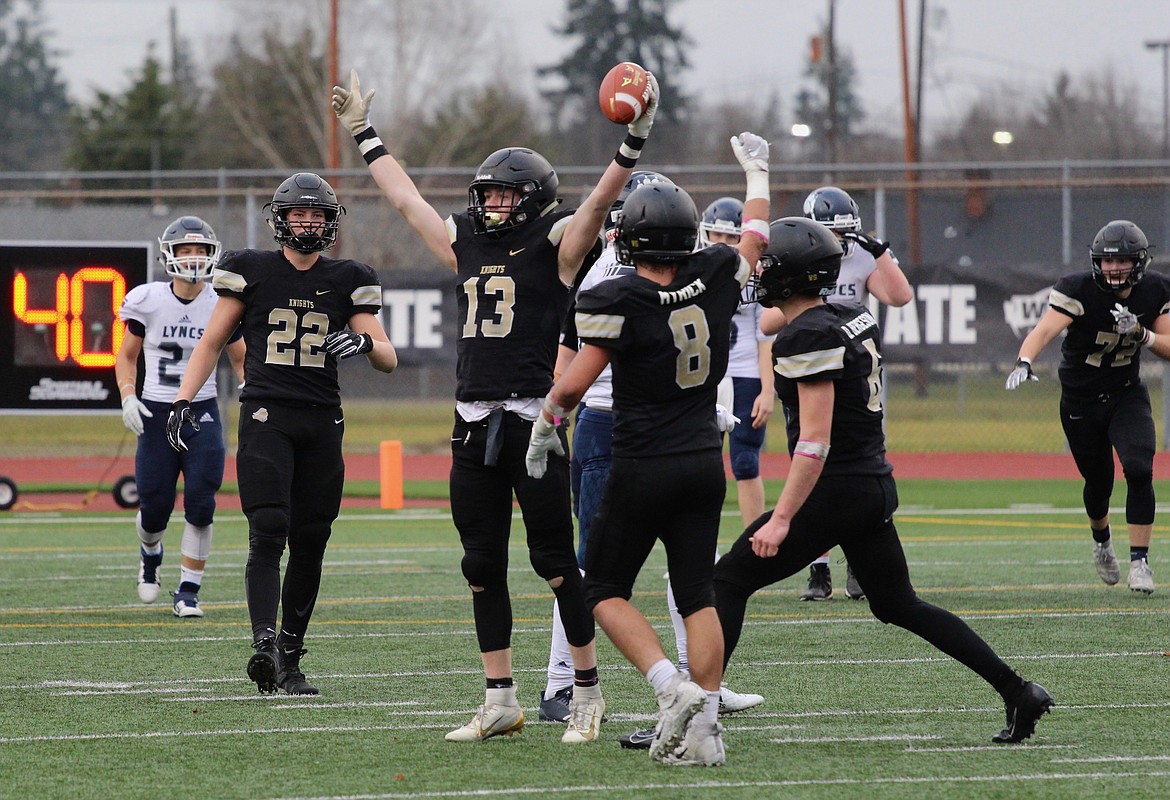 Casey McCarthy/Columbia Basin Herald Cooper Christensen raises the ball in celebration after sealing the title for the Knights with a late interception against the Lyncs.