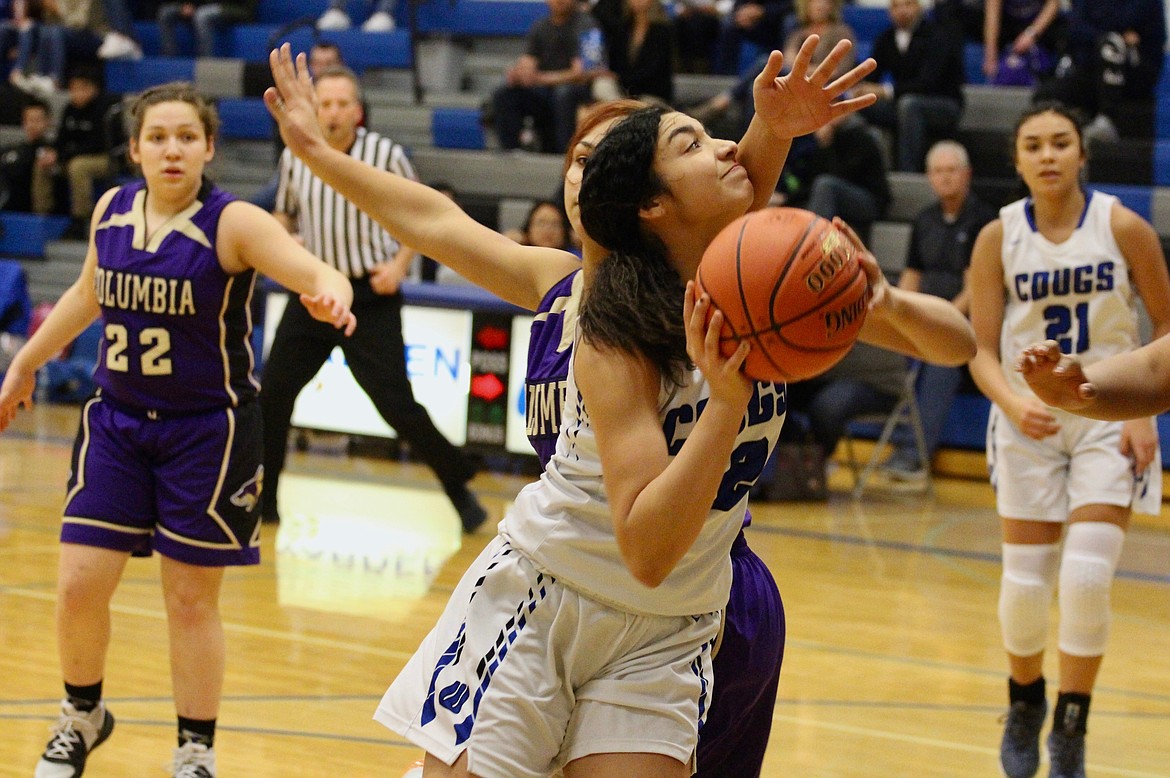 Casey McCarthy/Columbia Basin Herald Warden’s Kiana Rios goes in for the layup with a Columbia player draped on her in the first half on Tuesday at Warden High School.