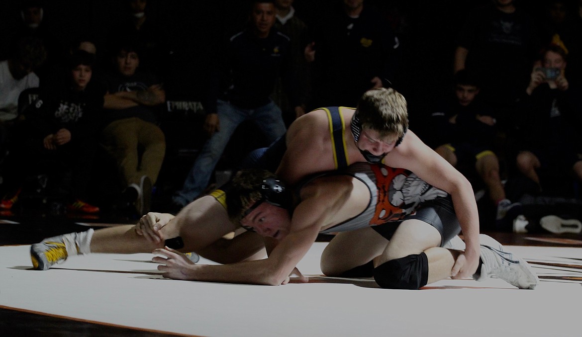 Casey McCarthy/Columbia Basin Herald Ephrata’s Carter Mills works to free himself in an early round. Mills defeated his opponent in overtime, giving the Tigers their first points in the matchup.