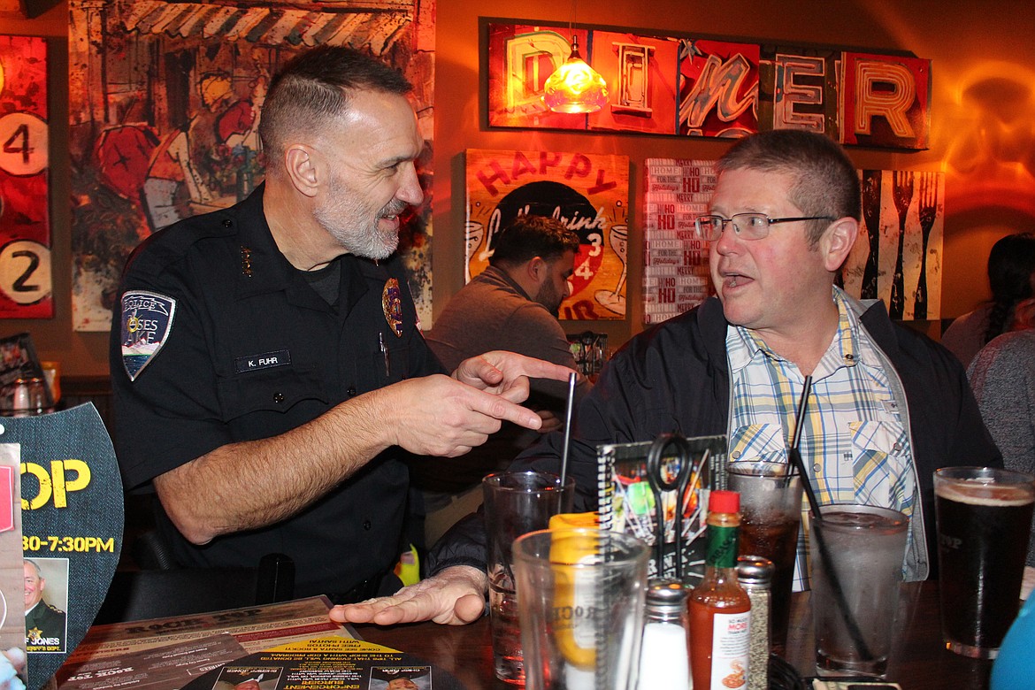 Moses Lake Police Chief Kevin Fuhr talks with customers during Tip A Cop night at the Rock Top restaurant Thursday, Money raised through Tip A Cop goes to the Shop with a Cop program.