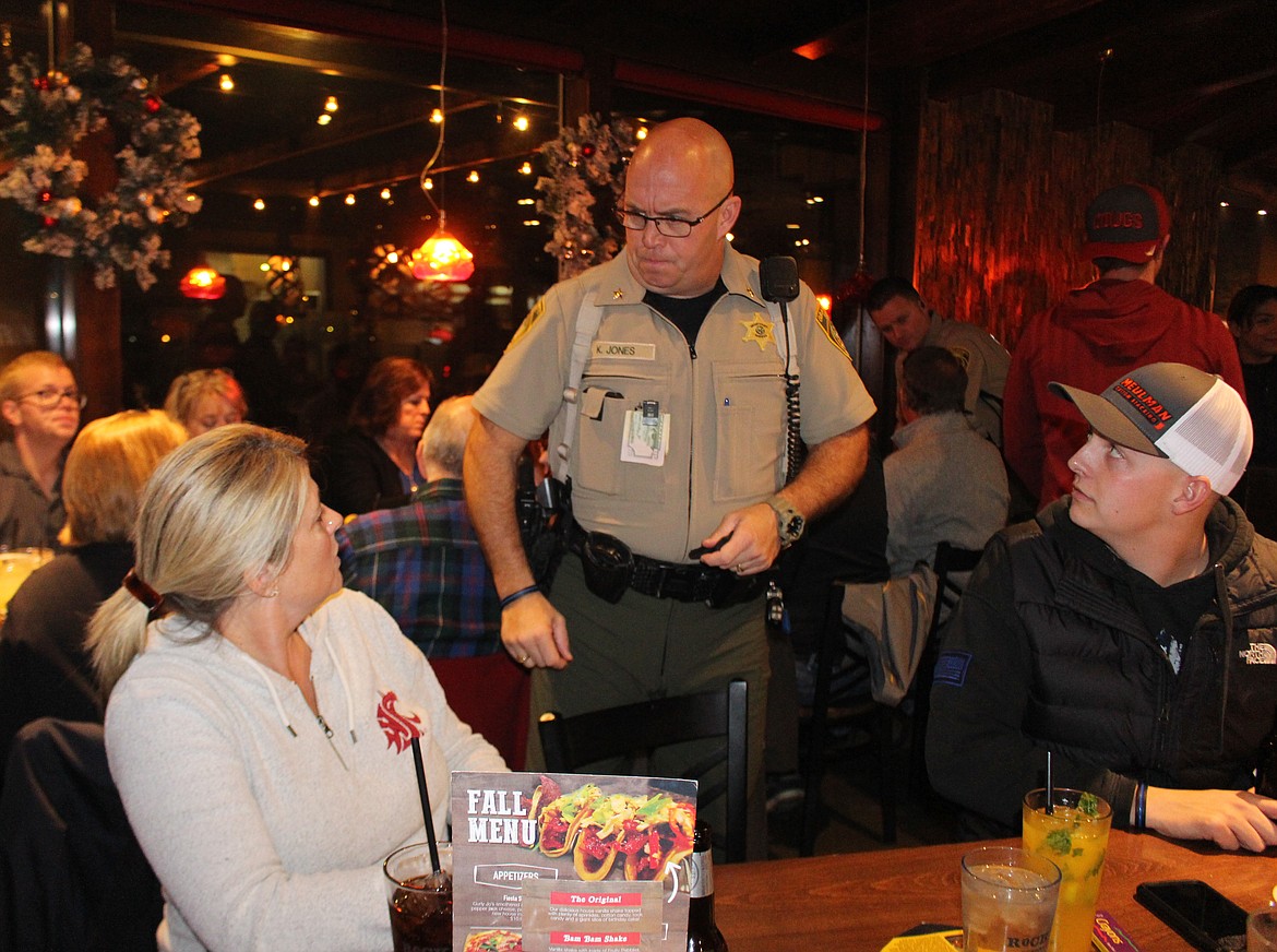 Ken Jones, chief deputy with the Grant County Sheriff’s Office, answers a question during Tip A Cop Thursday at the Rock Top restaurant. Proceeds are used for the Shop with a Cop program.