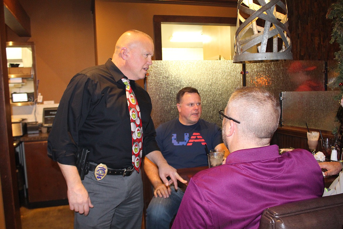 Dave Sands, captain with the Moses Lake Police Department, talks with customers during Tip A Cop Thursday at the Rock Top restaurant. Proceeds are donated to the Shop with a Cop program.