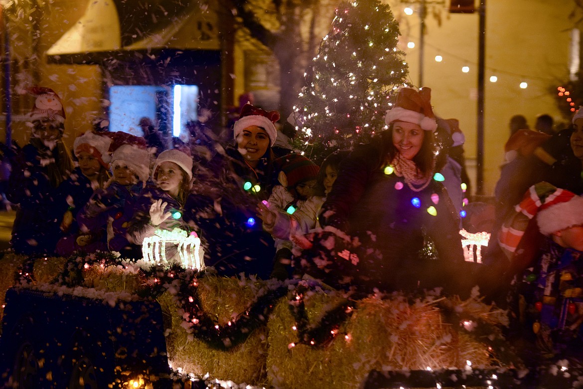Float riders wave, toss candy and blow snow from a snowmaker as part of Ephrata’s Miracle on Main Street Parade on Saturday.