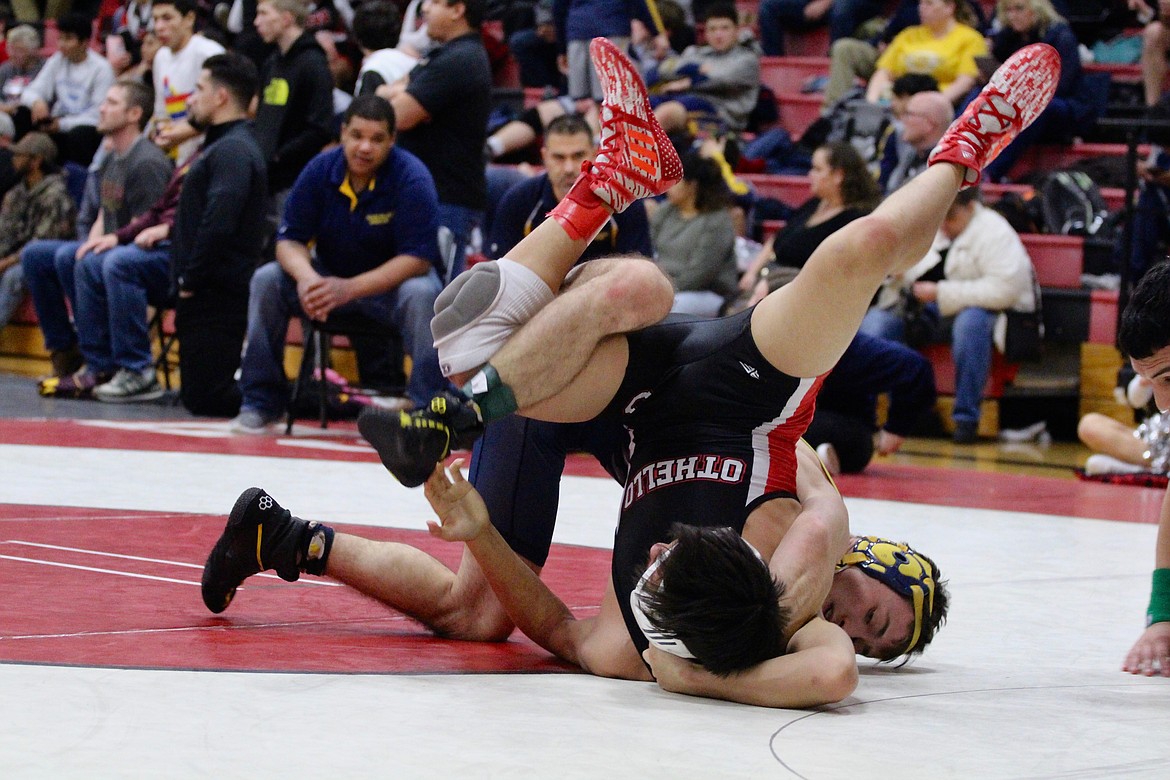 Casey McCarthy/Columbia Basin Herald Othello’s Miguel Amezola fights to break free from Devon Gantt of Naches Valley in the semifinal matchup of the 126 bracket on Saturday in Othello.