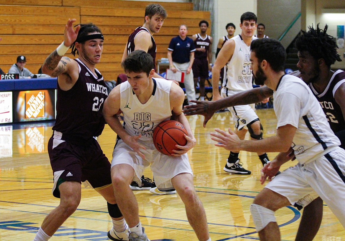 Casey McCarthy/Columbia Basin Herald Big Bend’s Jack McClary drives to the basket against the Whatcom player defending in the second half on Wednesday night.
