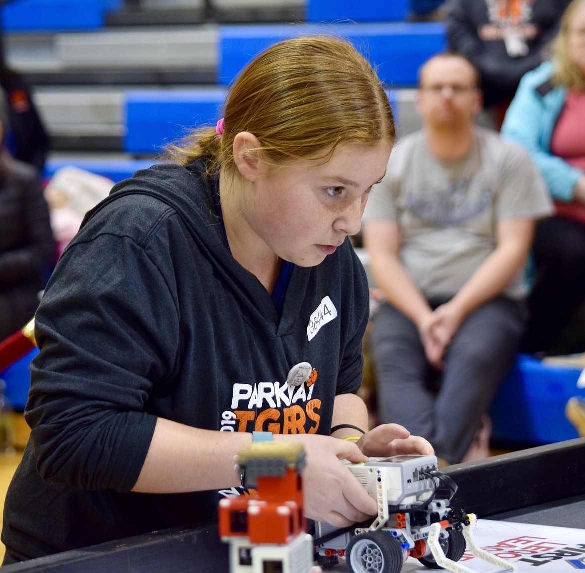 Parkway School 6th-grader Rylee Holt prepares the Parkway First Lego League robotics team robot during the first round of competition Saturday.