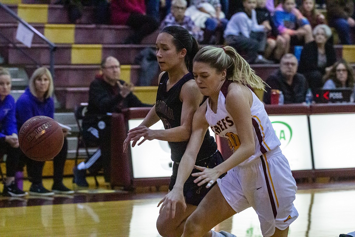 Casey McCarthy/Columbia Basin Herald Moses Lake Junior Anna Olson fights for the loose ball in the first half of the Chiefs win on Friday night at home.
