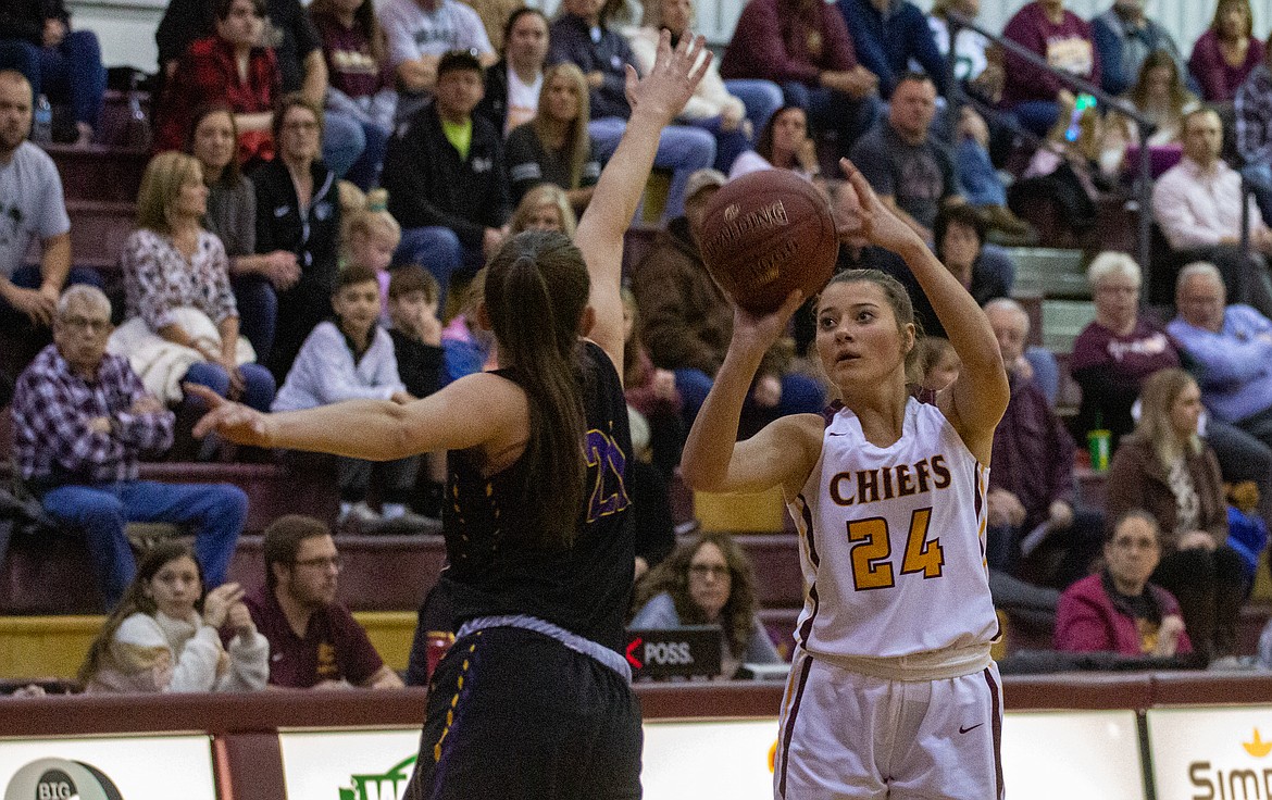Senior Madisyn Clark fires the shot from deep with an Issaquah player coming in to contest on Friday night at home.