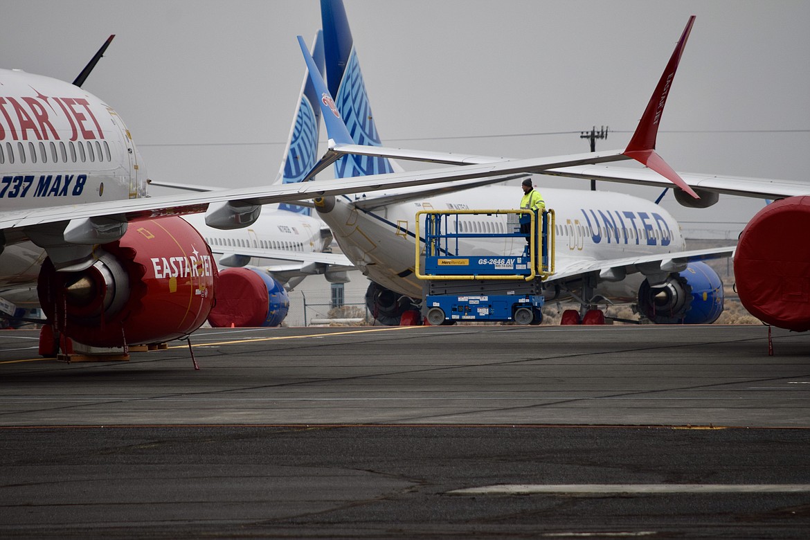 Charles H. Featherstone/Columbia Basin Herald 
 A lone Boeing employee drives a lift across the tarmac at the Port of Moses Lake on the way to inspecting one of roughly 200 Boeing 737 Max aircraft currently stored here.