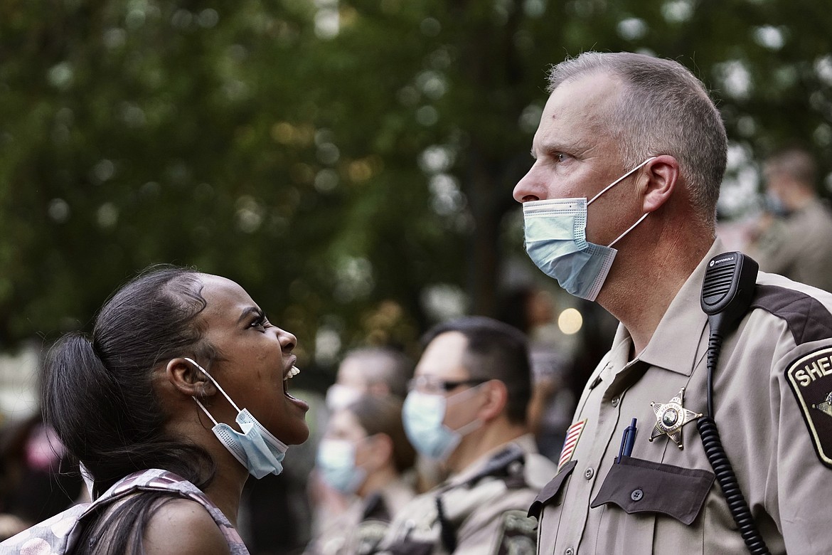 A woman yells at a sheriff's deputy during a protest following the death of George Floyd at the hand of Minneapolis police officers, Thursday, May 28, 2020, in Minneapolis. (Mark Vancleave/Star Tribune via AP)