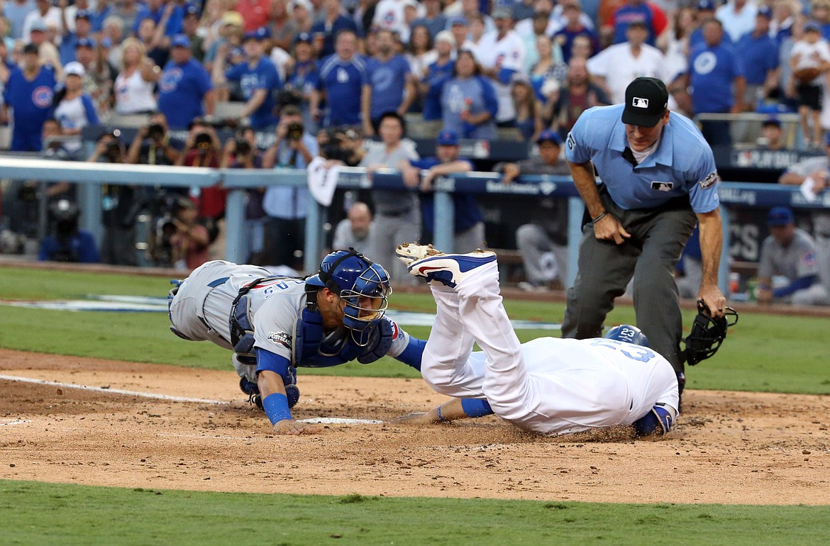 Nuccio DiNuzzo/TNS
The Los Angeles Dodgers&#146; Adrian Gonzalez is tagged out at the plate by Chicago Cubs catcher Willson Contreras, left, in the second inning in Game 4 of the National League Championship Series at Dodger Stadium in Los Angeles on Wednesday.