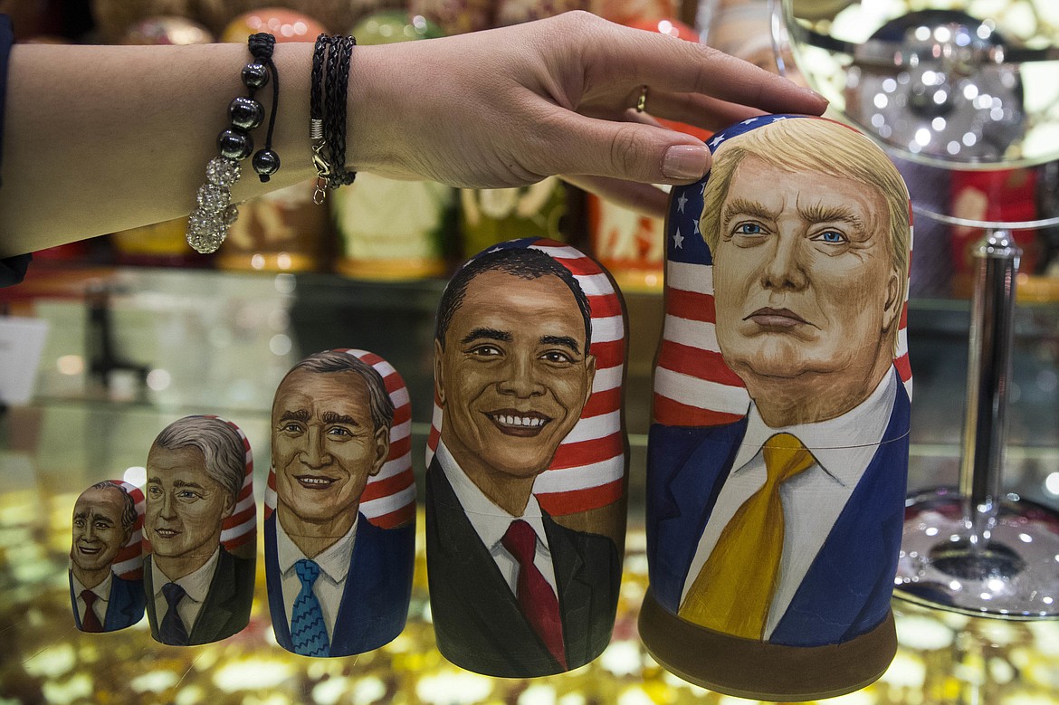 FILE - In this Tuesday, Nov. 8, 2016 file photo, traditional Russian wooden nesting dolls called Matreska depicting U.S. presidents, from left, George H.W. Bush, Bill Clinton, George W. Bush, Barack Obama and U.S. presidential candidate Donald Trump, are displayed in a shop in Moscow, Russia. Hacked emails, disclosed by WikiLeaks, revealed at-times embarrassing details from Democratic Party operatives in run-up to Election Day, leading to the resignation of Democratic National Committee chair Debbie Wasserman Schultz and other DNC officials. The CIA later concluded that Russia was behind the DNC hacking in a bid to boost Donald Trump's chances of beating Hillary Clinton. (AP Photo/Pavel Golovkin)