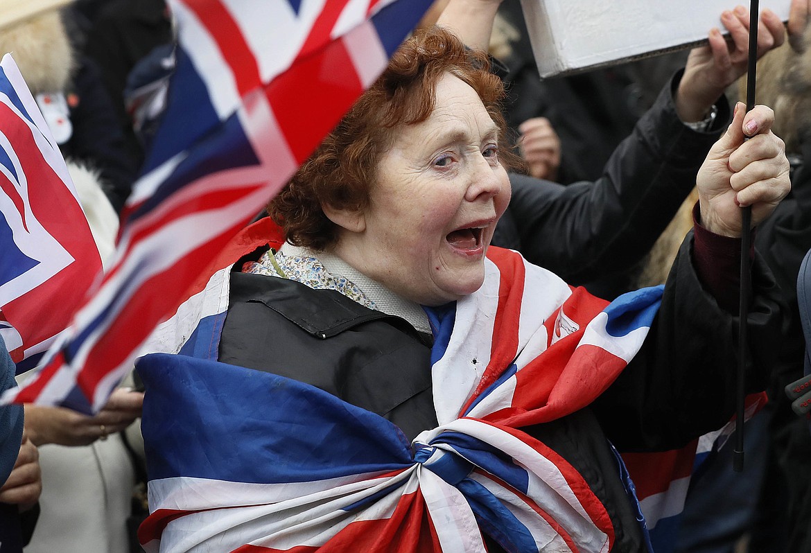 FILE - In this Wednesday, Nov. 23, 2016 file photo, &quot;Brexit&quot; supporters wave flags outside Parliament in London, timed to coincide with a statement by the treasury chief. Confounding pollsters and oddsmakers, Britons voted in June to leave the European Union, triggering financial and political upheaval. (AP Photo/Kirsty Wigglesworth)