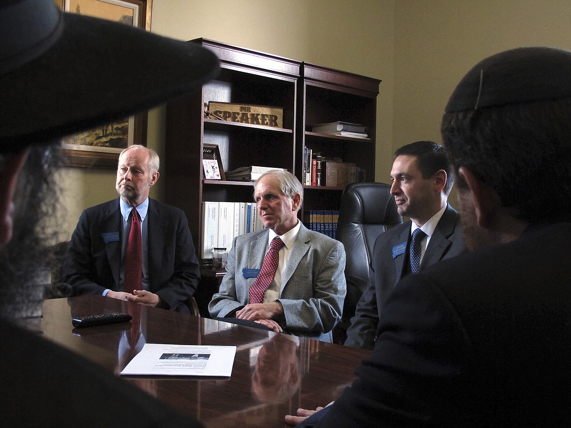 From left, Montana state Sen. Keith Regier, Rep. Dave Fern and House Speaker Austin Knudsen listen to a delegation of Orthodox Jewish rabbis from the U.S. and Canada Wednesday, Jan. 18, 2017, in Helena, Mont. The rabbis say they plan to counter white supremacist threats against the Jewish community in Whitefish, Mont., by sending students to visit the Auschwitz concentration camp and by sending the first five books of the Torah to every Jewish family in the state. (AP Photo/Matt Volz)