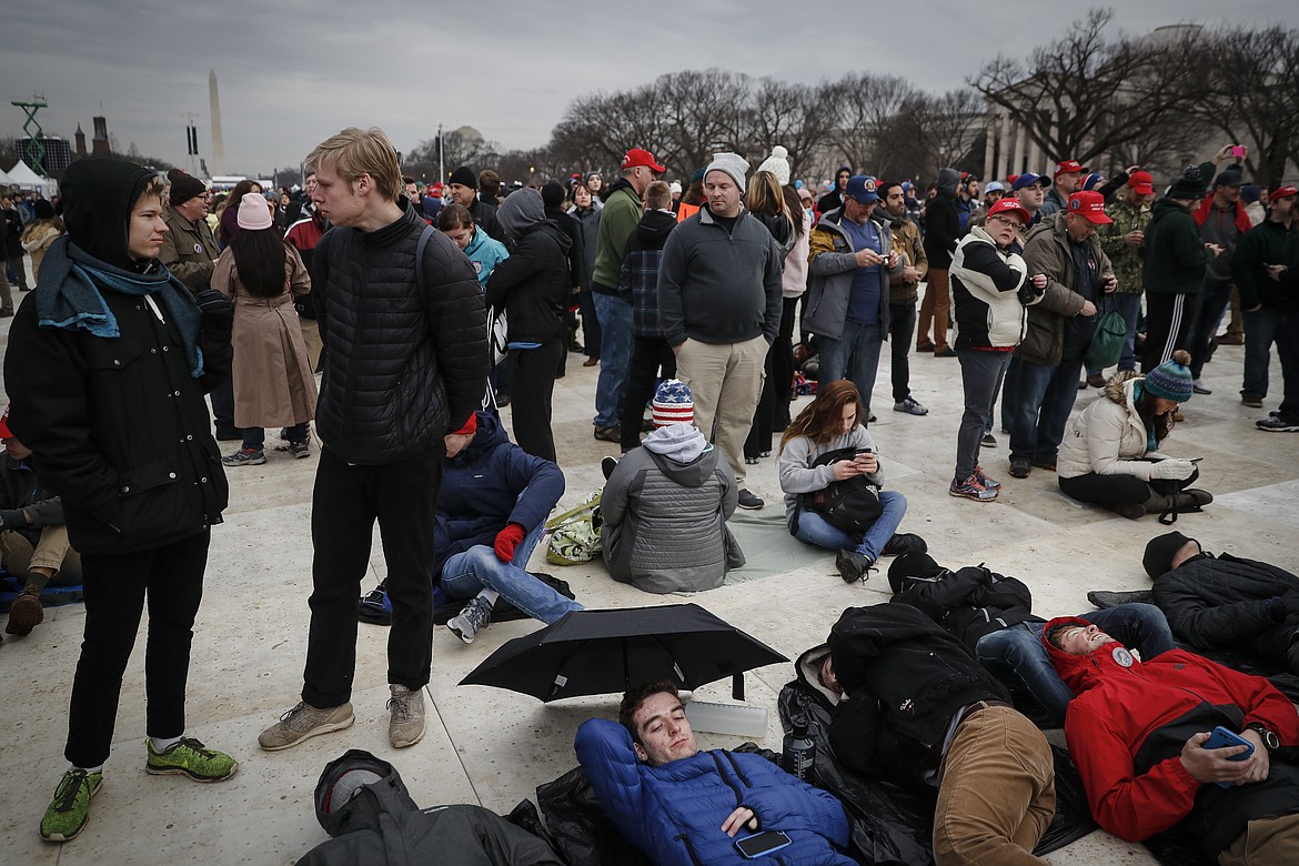 Spectators gather on the National Mall in Washington, Friday, Jan. 20, 2017, before the presidential inauguration of Donald Trump. (AP Photo/John Minchillo)