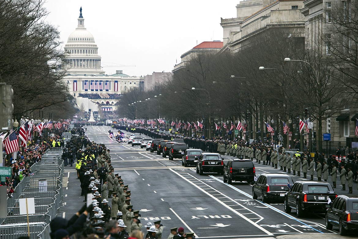 The Presidential motorcade drives on Pennsylvania Avenue to the Capitol for the Inauguration of President-elect Donald Trump, Friday, Jan. 20, 2017, in Washington. (AP Photo/Cliff Owen)