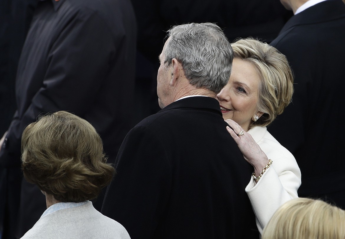 Former Secretary of State Hillary Clinton speaks to Former President George W. Bush and his wife Laura before the 58th Presidential Inauguration for President-elect Donald Trump at the U.S. Capitol in Washington, Friday, Jan. 20, 2017. (AP Photo/Matt Rourke)