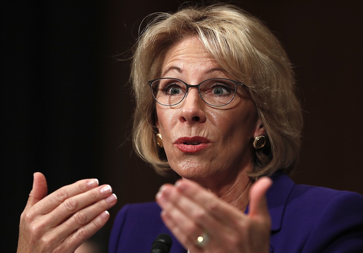 FILE - In this Jan. 17, 2017, file photo, Education Secretary-nominee Betsy DeVos testifies on Capitol Hill in Washington. Republicans are muscling more of President Donald Trump&#146;s Cabinet nominees to the cusp of Senate confirmation over Democratic objections, with committees poised to advance his picks to head agencies in the thick of partisan battles over health care, legal protections, education and the economy. (AP Photo/Carolyn Kaster, File)