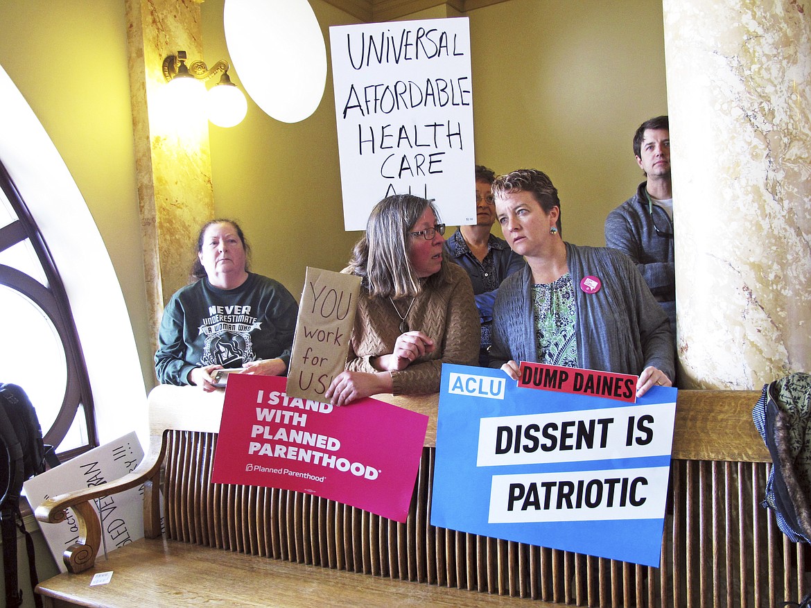 Protesters wait for U.S. Sen. Steve Daines to hold a news conference in the Montana Capitol in Helena Wednesday, Feb. 22, 2017. Hundreds of demonstrators rallied at the Capitol a day earlier to demand that Daines hold a town hall meeting with them, but the Republican senator rescheduled his appearance until Wednesday, drawing fewer protesters. Republicans who benefited from rowdy town halls six years ago and harnessed a wave of discontent with Democrats to win seats in Congress are learning a hard lesson this week as they return home: The left is happy to return the favor. (AP Photo/Matt Volz)