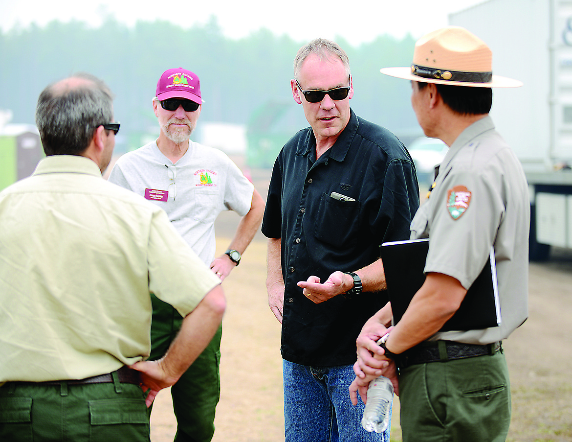 Congressman Ryan Zinke (R) speaks with Superintendent of Glacier National Park, Jeff Mow, and first responders for the fires in the Essex area on Friday, August 28, at incident command in West Glacier.
(Brenda Ahearn/Daily Inter Lake)