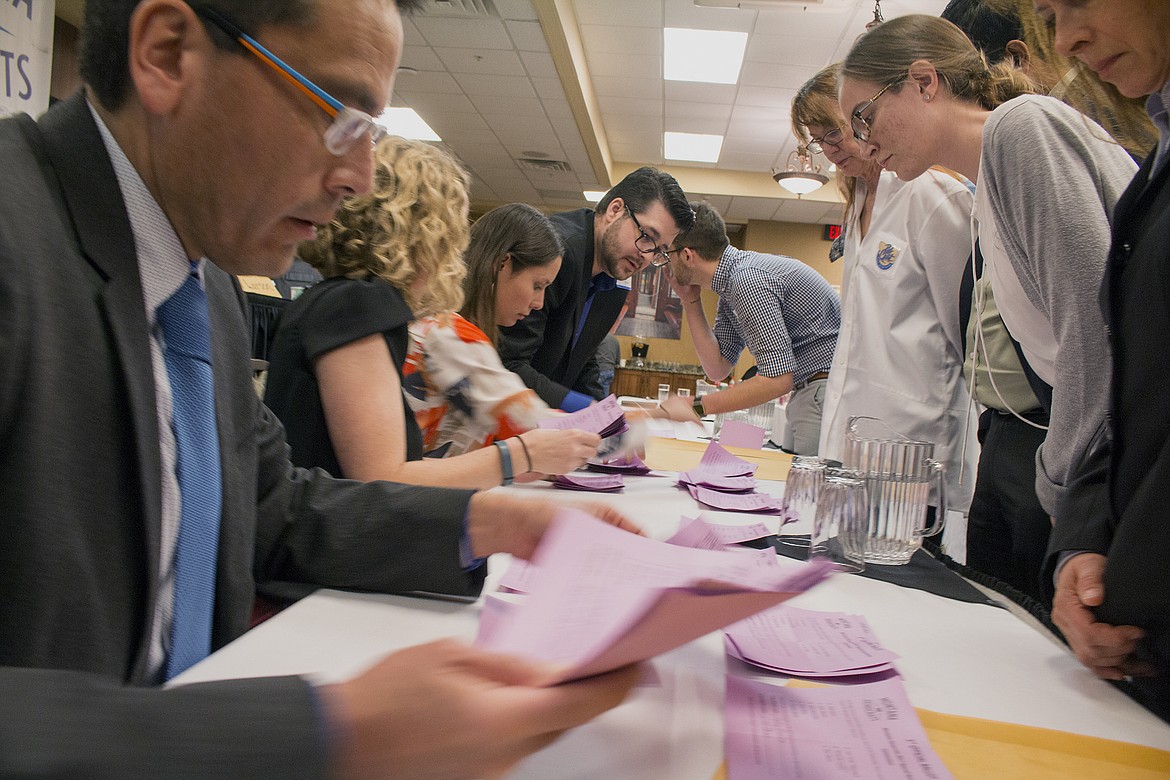 Democratic party officials count ballots under the watch of representatives of candidates seeking the party&#146;s nomination for the special congressional election in Helena on Sunday. (AP Photo/Bobby Caina Calvan)