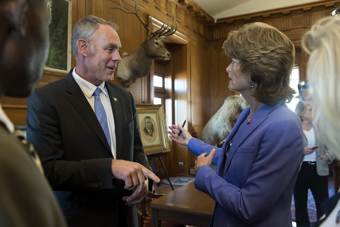 Former Interior Secretary Ryan Zinke speaks with Sen. Lisa Murkowski, R-Alaska, at the Interior Department in Washington on Wednesday, March 29, 2017, after signing an order lifting a moratorium on new coal leases on federal lands and a related order on coal royalties. (Molly Riley/Associated Press)