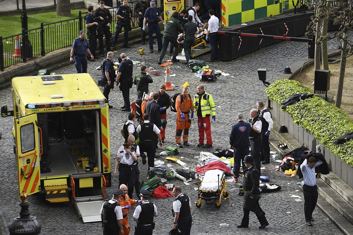 Emergency services at the scene outside the Palace of Westminster, London, Wednesday, March 22, 2017.  London police say they are treating a gun and knife incident at Britain&#146;s Parliament &#147;as a terrorist incident until we know otherwise.&#148; The Metropolitan Police says in a statement that the incident is ongoing. It is urging people to stay away from the area. Officials say a man with a knife attacked a police officer at Parliament and was shot by officers. Nearby, witnesses say a vehicle struck several people on the Westminster Bridge.  (Stefan Rousseau/PA via AP).