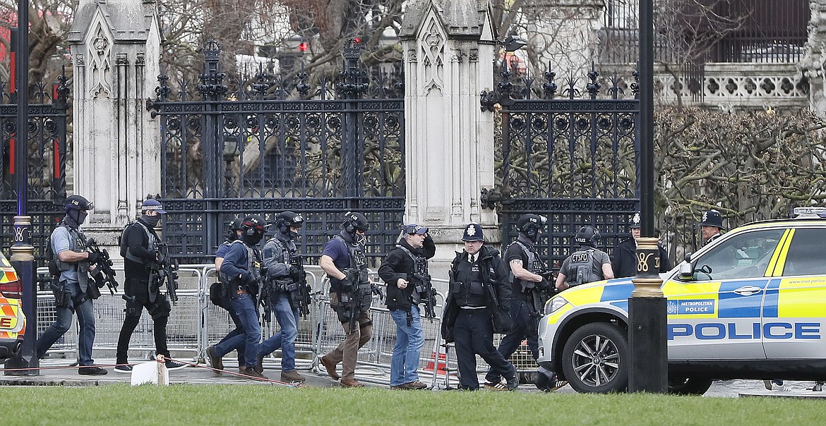 Armed police officers enter the Houses of Parliament in London, Wednesday, March 23, 2017 after the House of Commons sitting was suspended as witnesses reported sounds like gunfire outside.(AP Photo/Kirsty Wigglesworth)