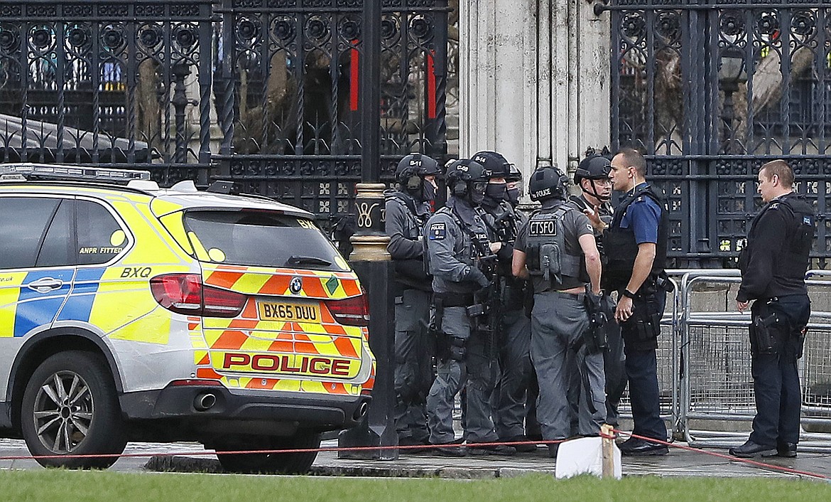 Armed police officers gather outside of the Houses of Parliament in London, Wednesday, March 23, 2017 after the House of Commons sitting was suspended as witnesses reported sounds like gunfire outside. The leader of Britain&#146;s House of Commons says a man has been shot by police at Parliament. David Liddington also said there were &#147;reports of further violent incidents in the vicinity.&#148;(AP Photo/Kirsty Wigglesworth)