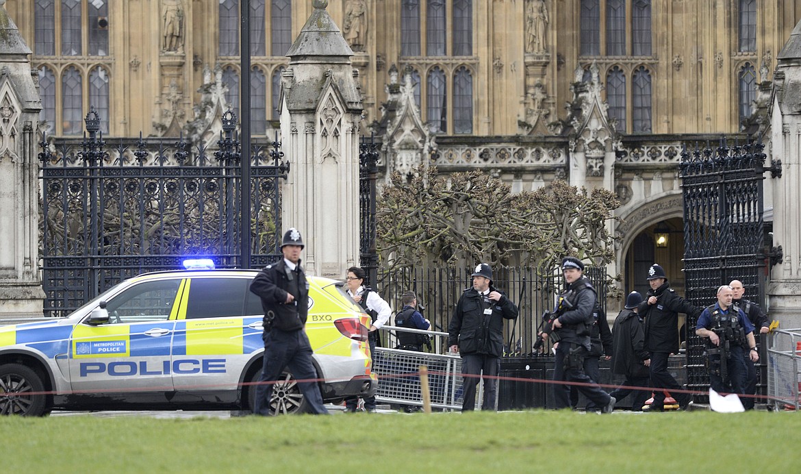 Police on the scene after sounds similar to gunfire have been heard close to the Houses of Parliament, London, Wednesday, March 22, 2017. London police say officers called to &#145;firearms incident&#146; on Westminster Bridge, near Parliament. (Victoria Jones/PA via AP)