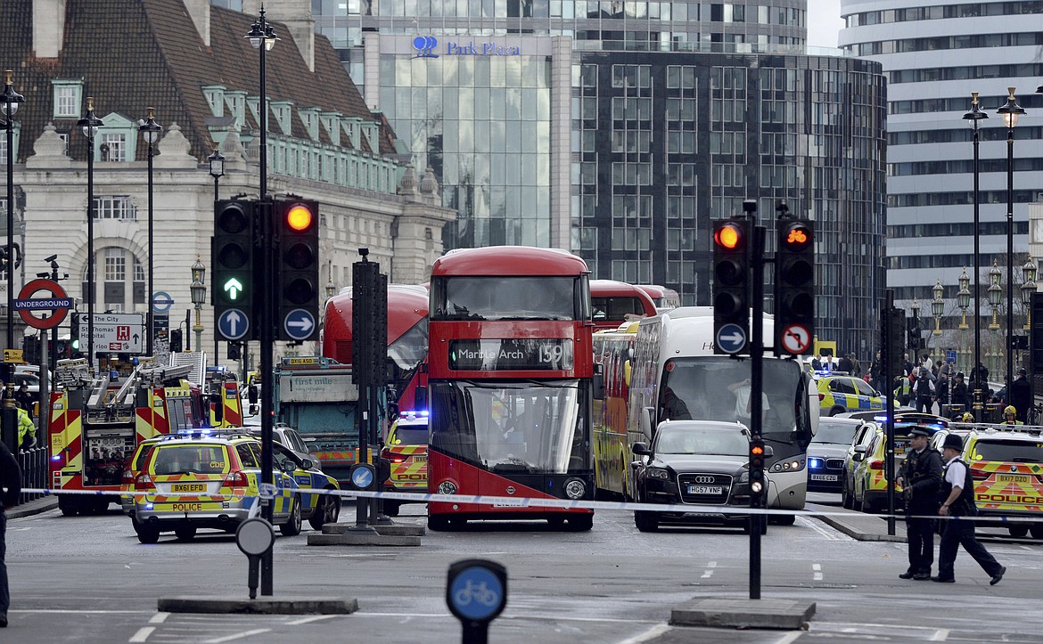 Roads are closed off by police after sounds similar to gunfire have been heard close to the Houses of Parliament, London, Wednesday, March 22, 2017. The UK House of Commons sitting has been suspended as witnesses report sounds like gunfire outside. (Victoria Jones/PA via AP)