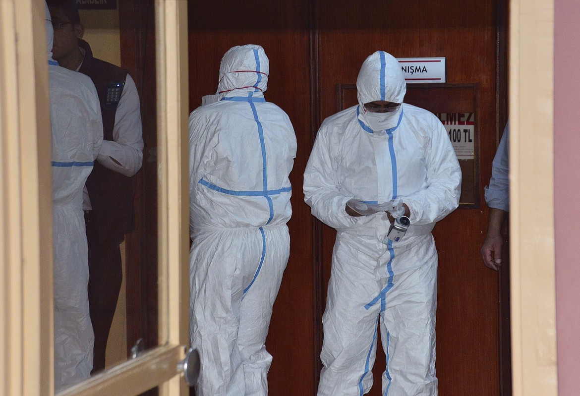 In this photo taken on late Wednesday, April 5, 2017 and made available Thursday, April 6, World Health Organization experts work as they take part in an autopsy conducted in a hospital in Adana, Turkey. Turkey&#146;s Justice Minister Bekir Bozdag said autopsy results show Syrians were subjected to chemical weapons attack in Idlib, Syria, on Tuesday. (DHA-Depo Photos via AP)
