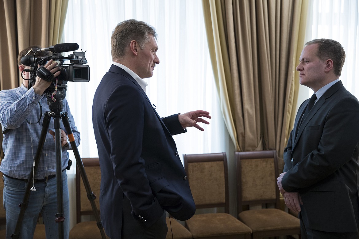 President Vladimir Putin&#146;s spokesman Dmitry Peskov, center, speaks with Ian Phillips, vice president International News Associated Press, at a meeting with The Associated Press in Moscow, Russia, Thursday, April 6, 2017. The spokesman for President Vladimir Putin tells The Associated Press Russia&#146;s support for Syrian President Bashar Assad is not unconditional. Thursday&#146;s statement from Dmitry Peskov comes several days after a suspected chemical weapons attack on a rebel-held province. (AP Photo/Pavel Golovkin)