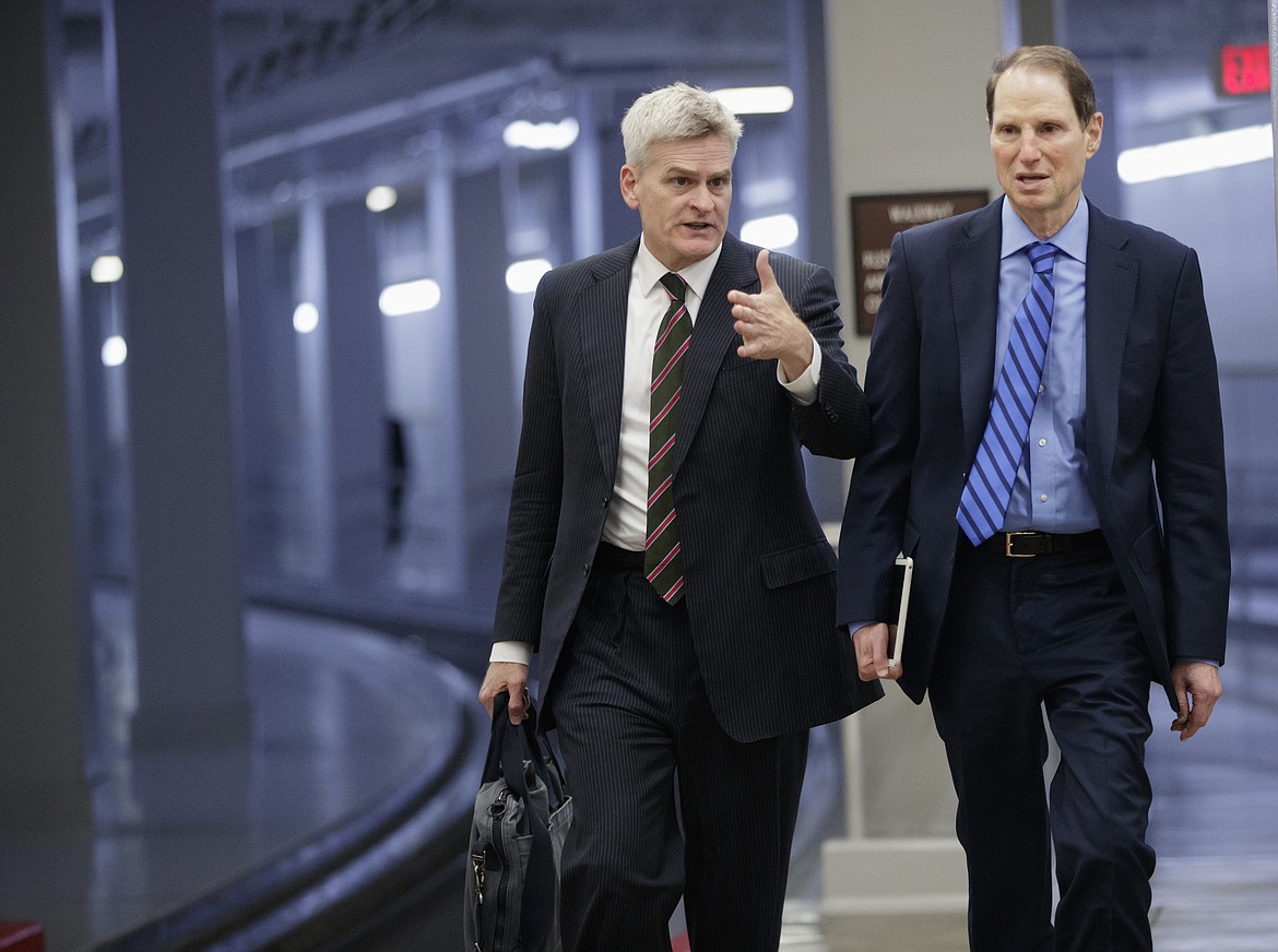 Sen. Bill Cassidy, R-La., left, walks with Sen. Ron Wyden, D-Ore., as they arrive for the scheduled cloture vote to end debate on President Donald Trump's Supreme Court nominee Neil Gorsuch, on Capitol Hill in Washington, Thursday, April 6, 2017. (AP Photo/J. Scott Applewhite)