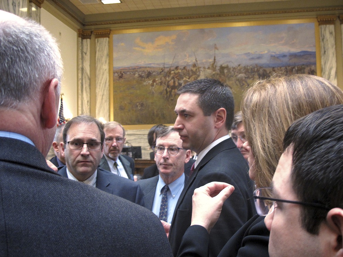 Montana House Speaker Austin Knudsen stands in the center of   legislators after the House voted down an infrastructure package for the fifth time on Friday, April 28, 2017, in Helena, Mont. The Montana Legislature plans to adjourn later Friday, with or without the $80 million infrastructure bill that has become the most contentious issue of the legislative session. (AP Photo/Matt Volz)